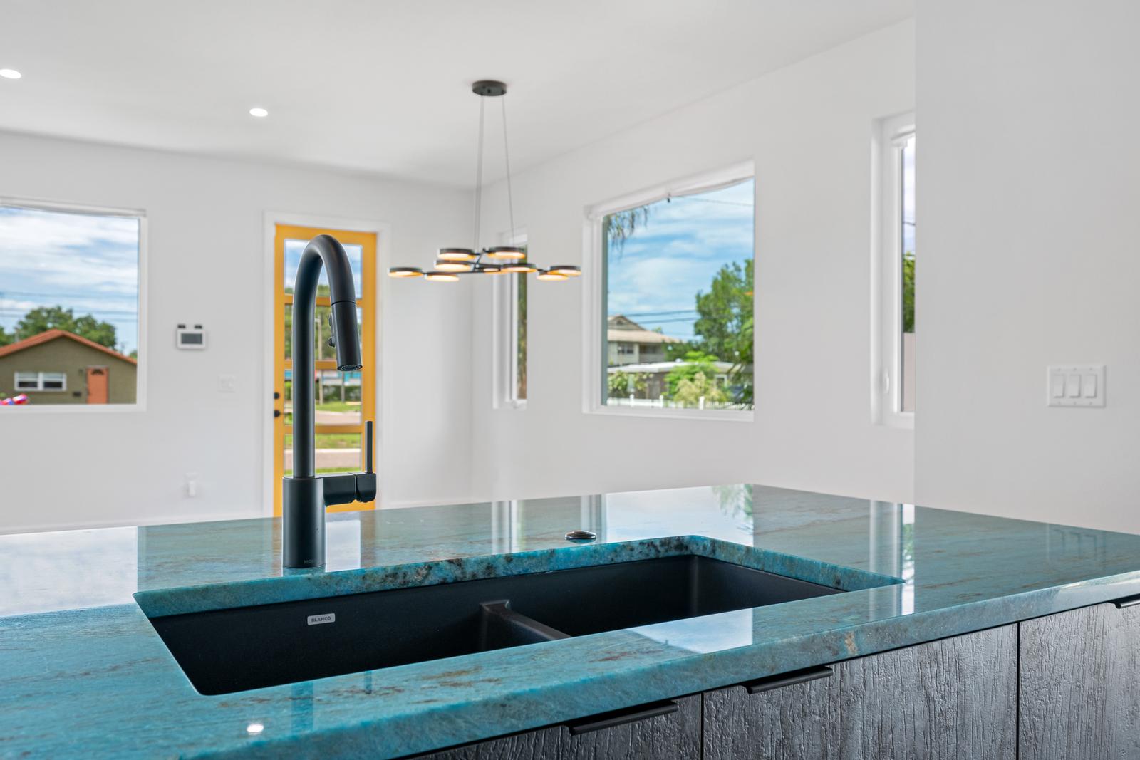 Blue-green natural stone island with black sink