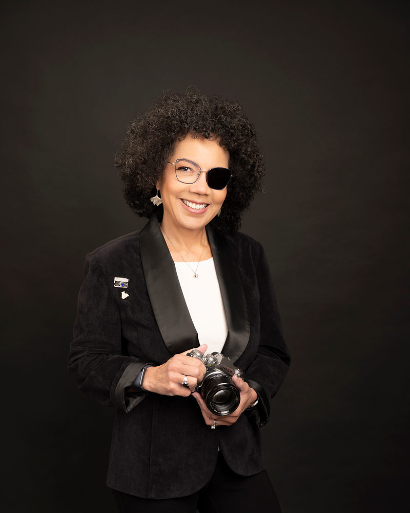 Rachel Rausch, portrait photographer, holding her camera