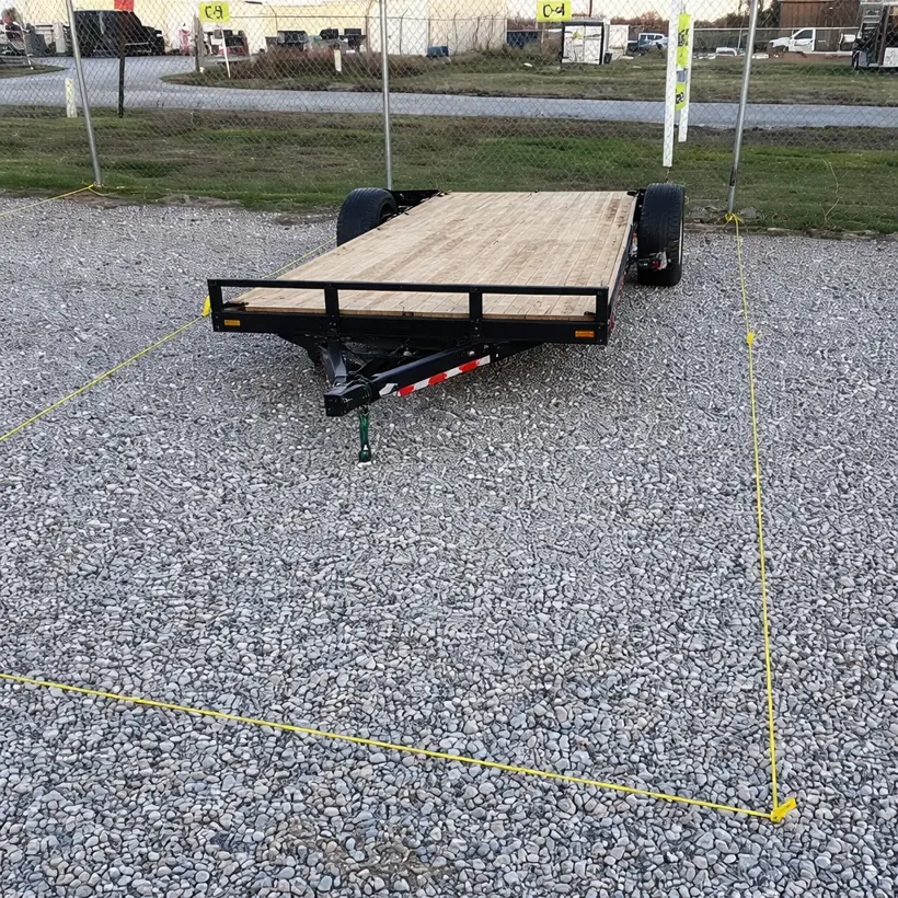 Flatbed trailer parked in a marked gravel parking space at the 37th Street location in Lawton, OK