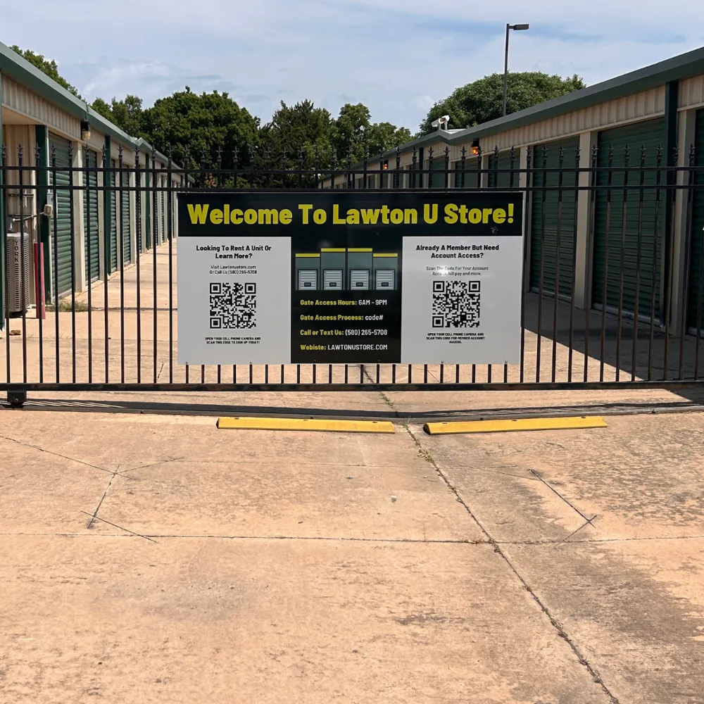 Fenced and gated entrance with the Welcome to Lawton U Store sign