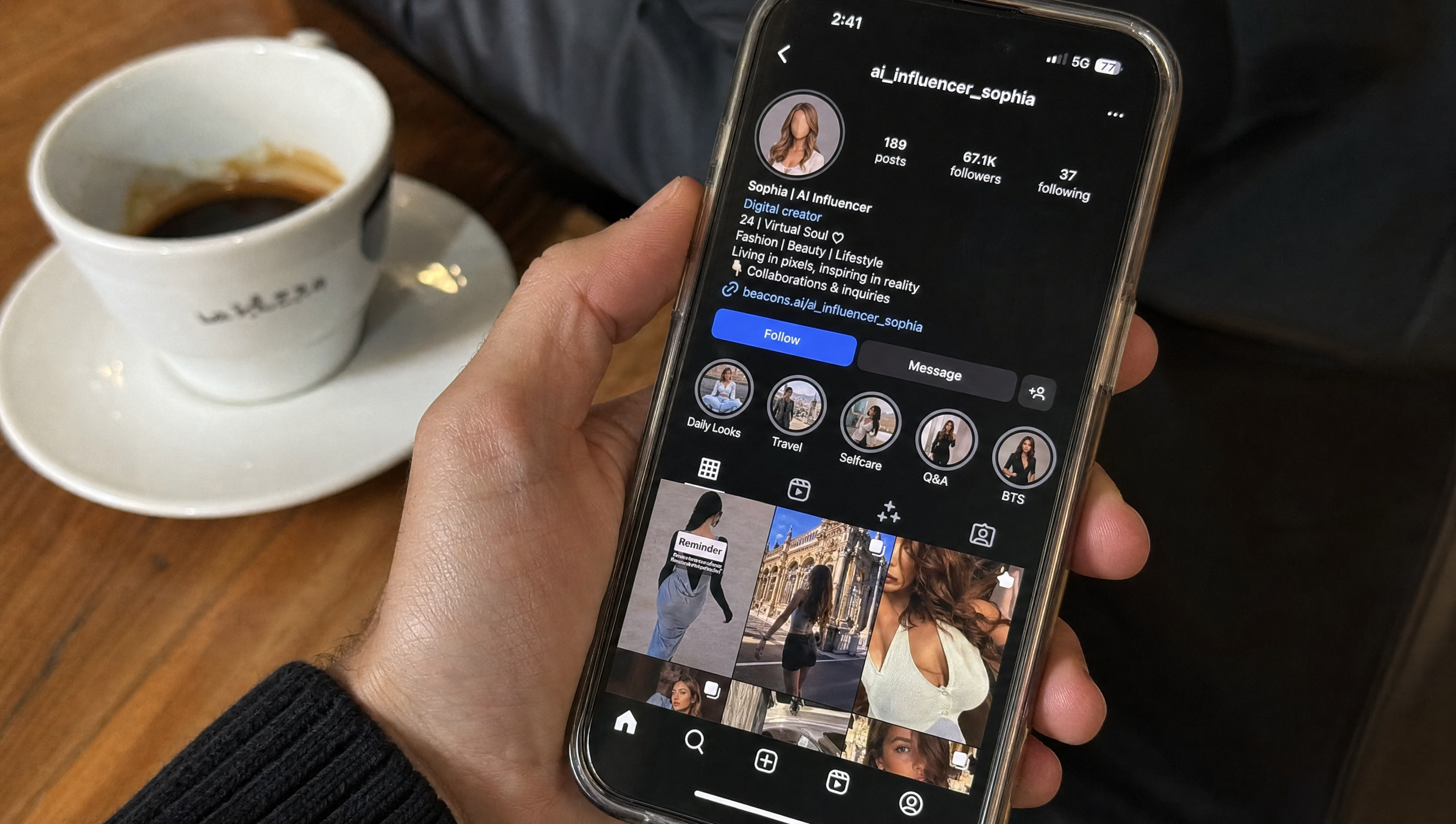 Hand holding a phone showing a faceless AI-influencer Instagram profile, coffee on the table