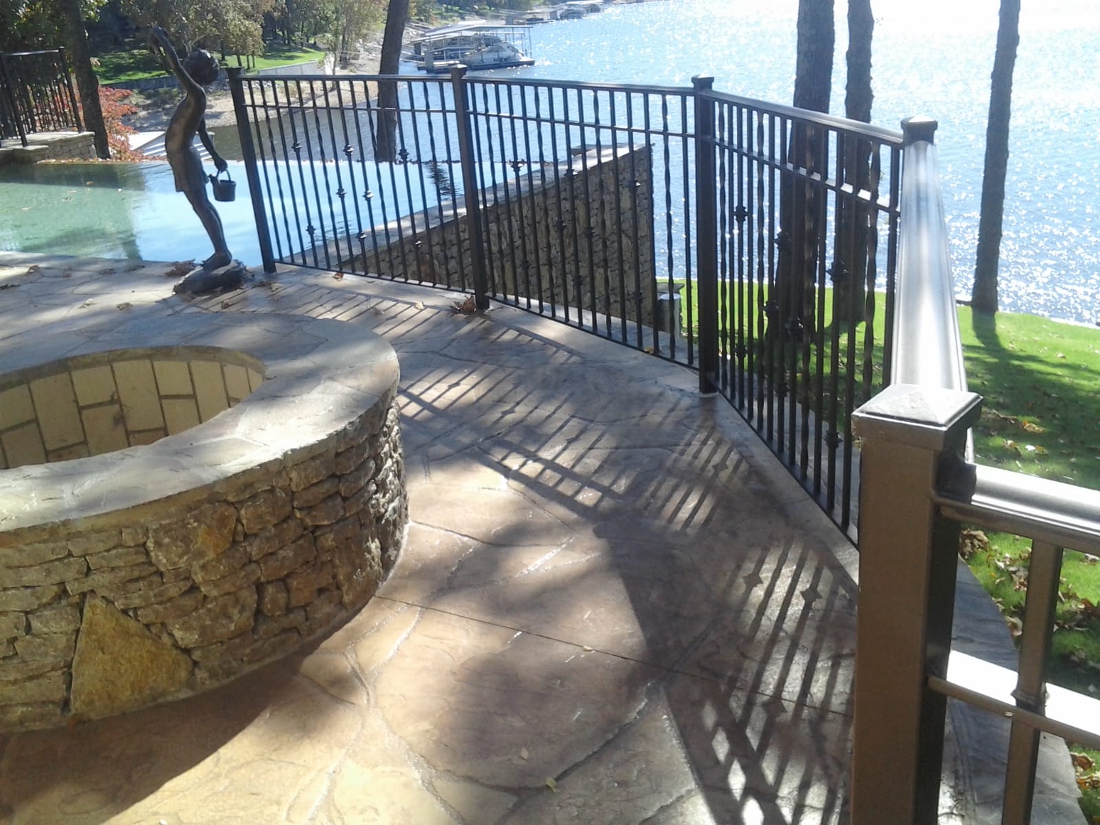 Close-up of a black ornamental metal fence providing security for a property