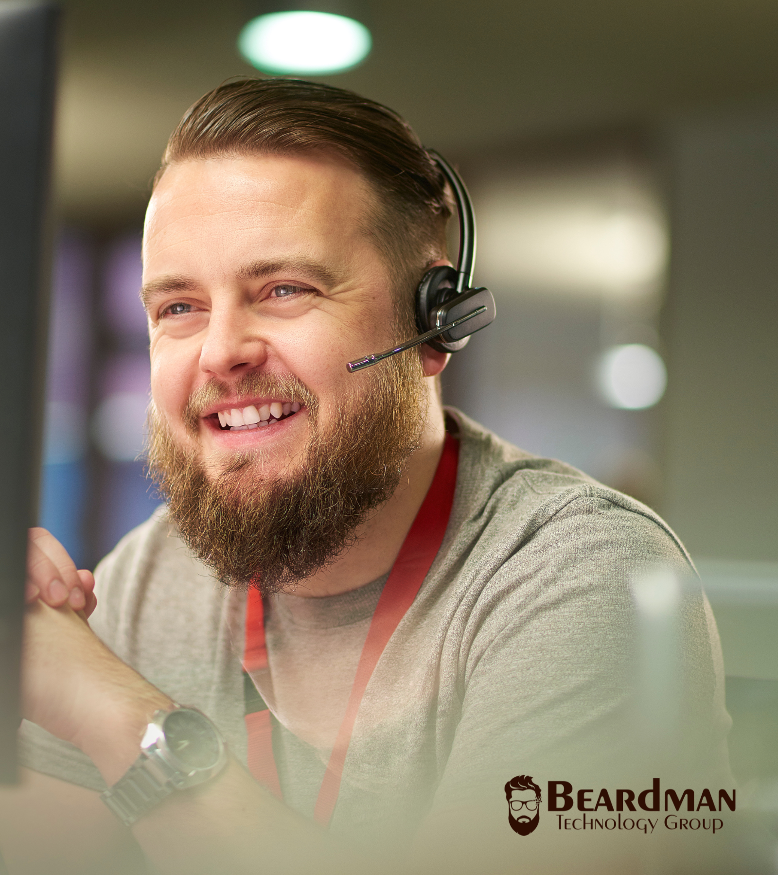Managed IT Support Agent with Headset. Beardman Technology Group Logo Bottom Left