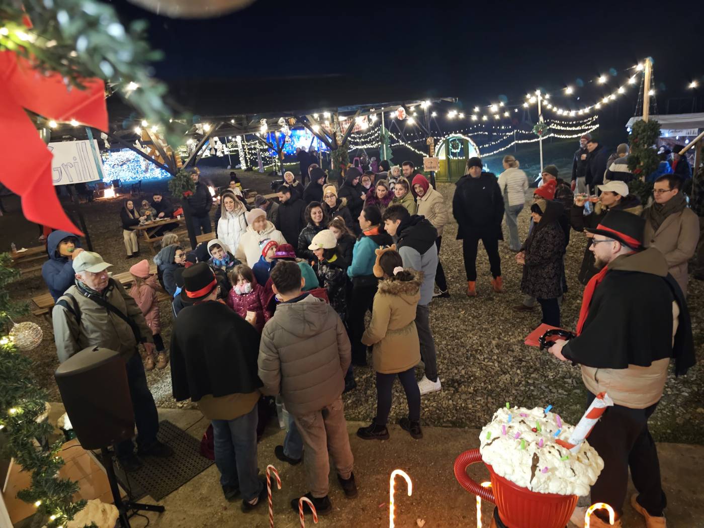 Neighbors gathered at our Christmas festival under string lights