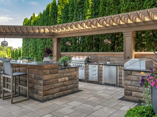 Custom paver patio in Naperville backyard with outdoor kitchen