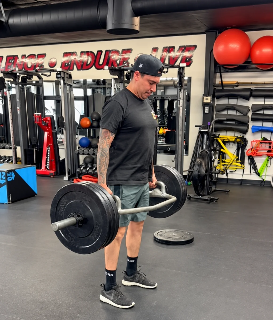 Athlete performing heavy trap-bar deadlift for sports performance at Xcel Fitness