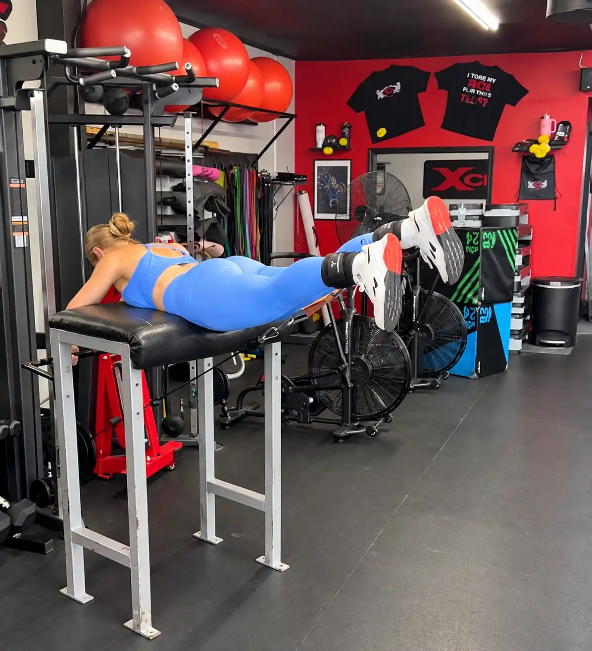 Member training on a strength machine at Xcel Fitness
