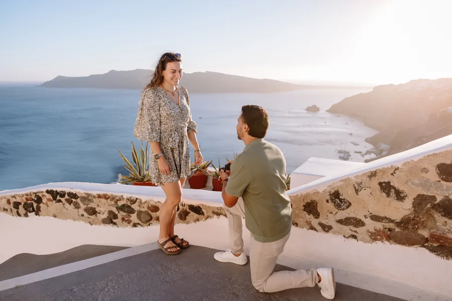 Ricardo on one knee on the terrace, Elise’s hand at her mouth