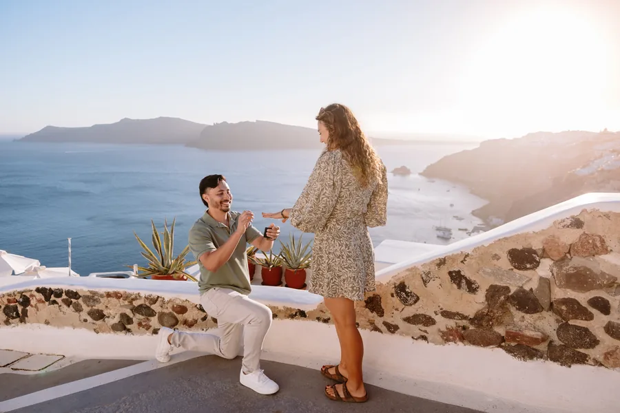 Ricardo takes Elise’s hand at the terrace wall