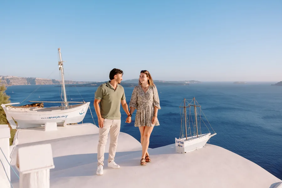 Hand in hand on the rooftop beside the boat