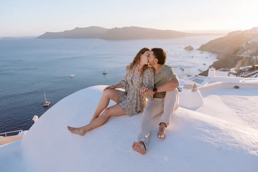 Elise tucked under Ricardo’s arm on the dome, the bay far below