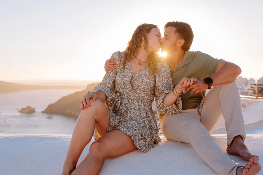 Sitting on the dome, a kiss with the sun caught between them