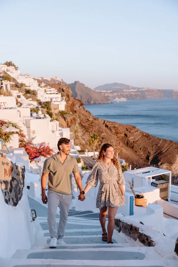 On the steps, hand in hand, the whole bay behind them