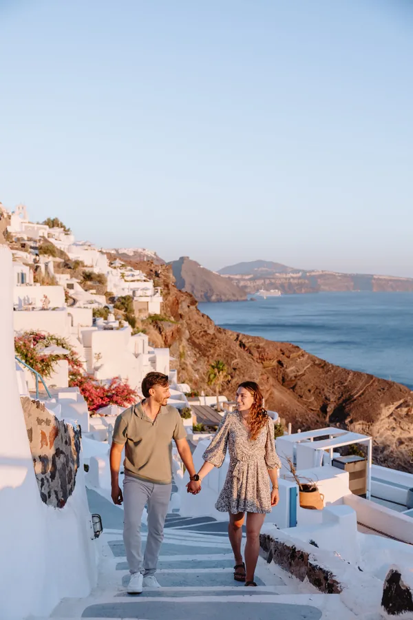 The two of them walking down the steps, bougainvillea above