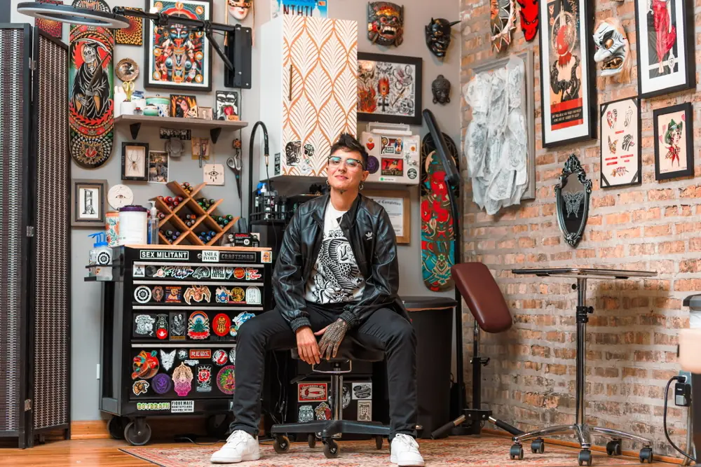 Orne seated in her studio surrounded by artwork