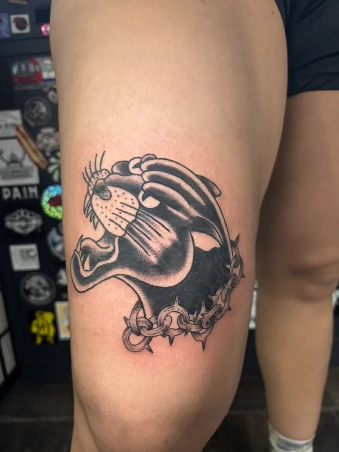 Black traditional panther tattoo on thigh by Orne