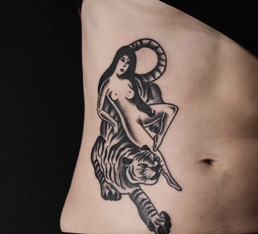 Woman riding a tiger tattoo on ribs by Orne