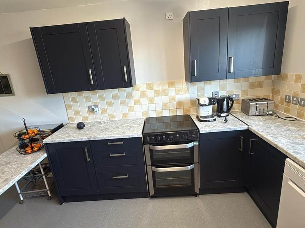 Refurbished kitchen with navy units and new worktops