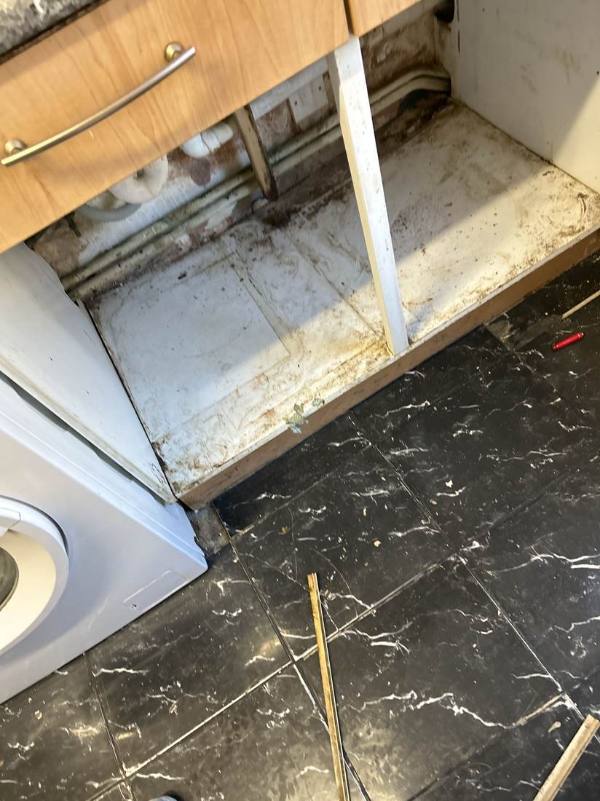 Damaged kitchen base unit with broken shelving