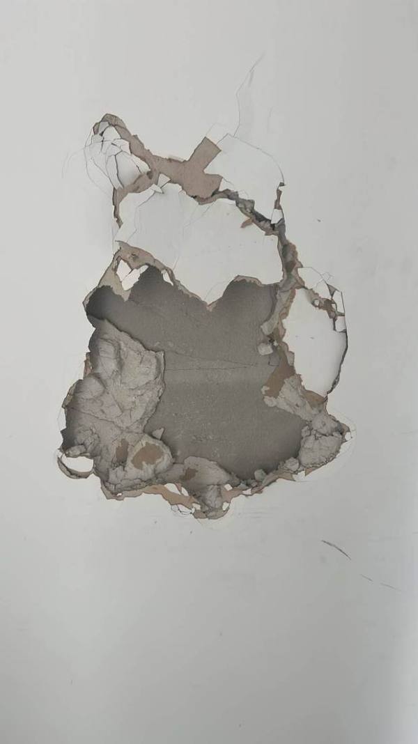 Large hole in a plasterboard wall