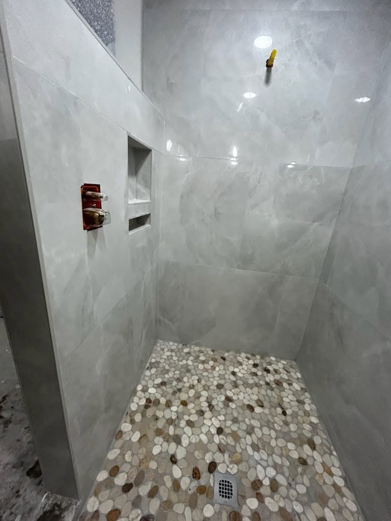 Marble walls with pebble floor shower