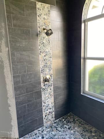 Dark shower with river-stone accent
