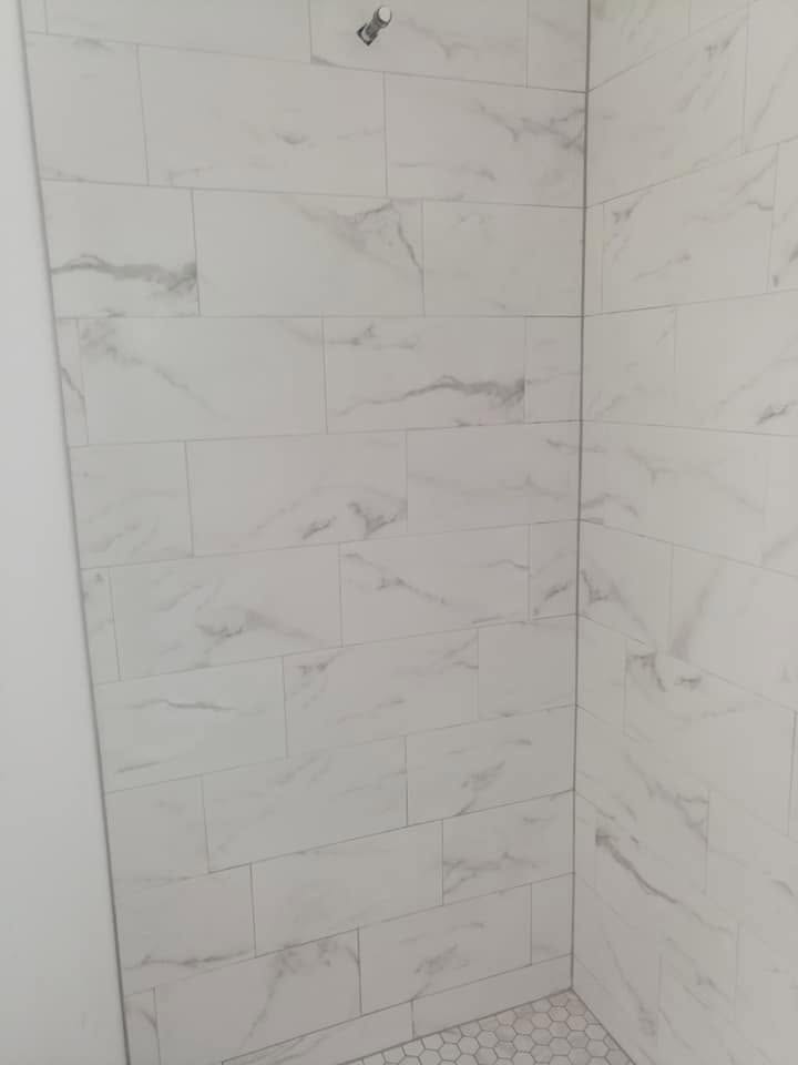 Marble walls with hex floor shower corner