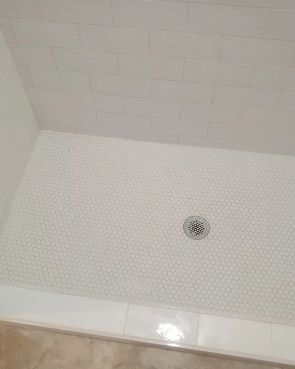 White subway walls with penny tile floor