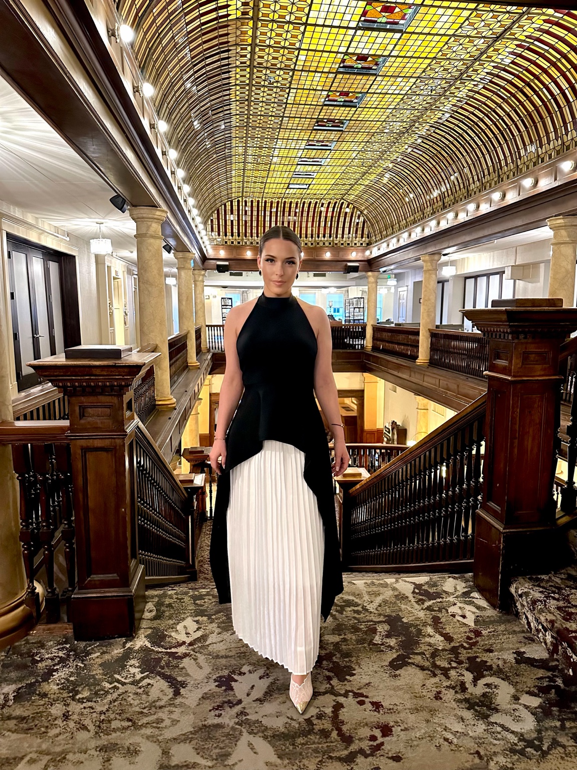 Client in a black-and-white dress at an ornate venue