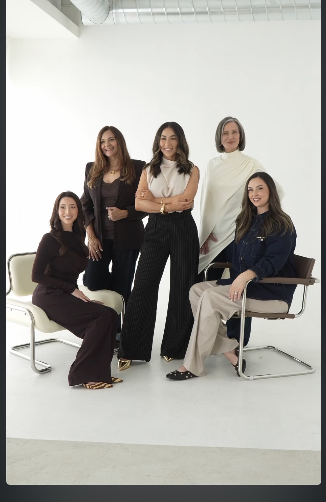 Five team members styled in coordinated looks for a branding shoot