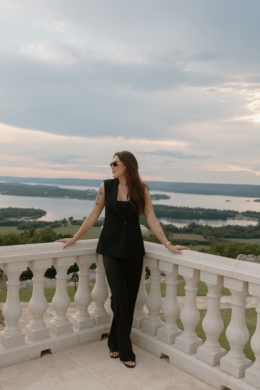 Client in a tailored black outfit on an outdoor balcony