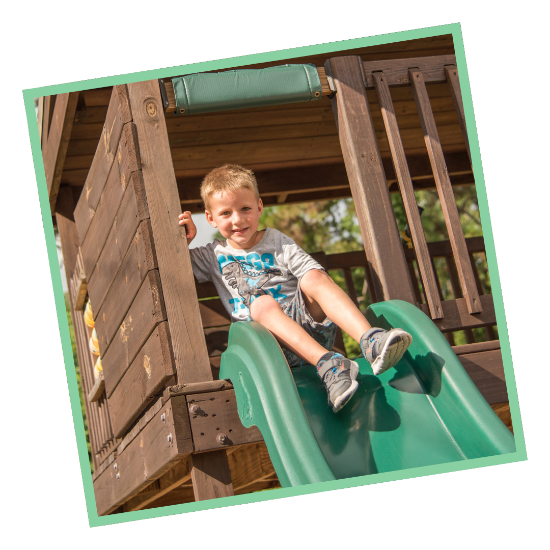 chld playing on slide in childcare playground