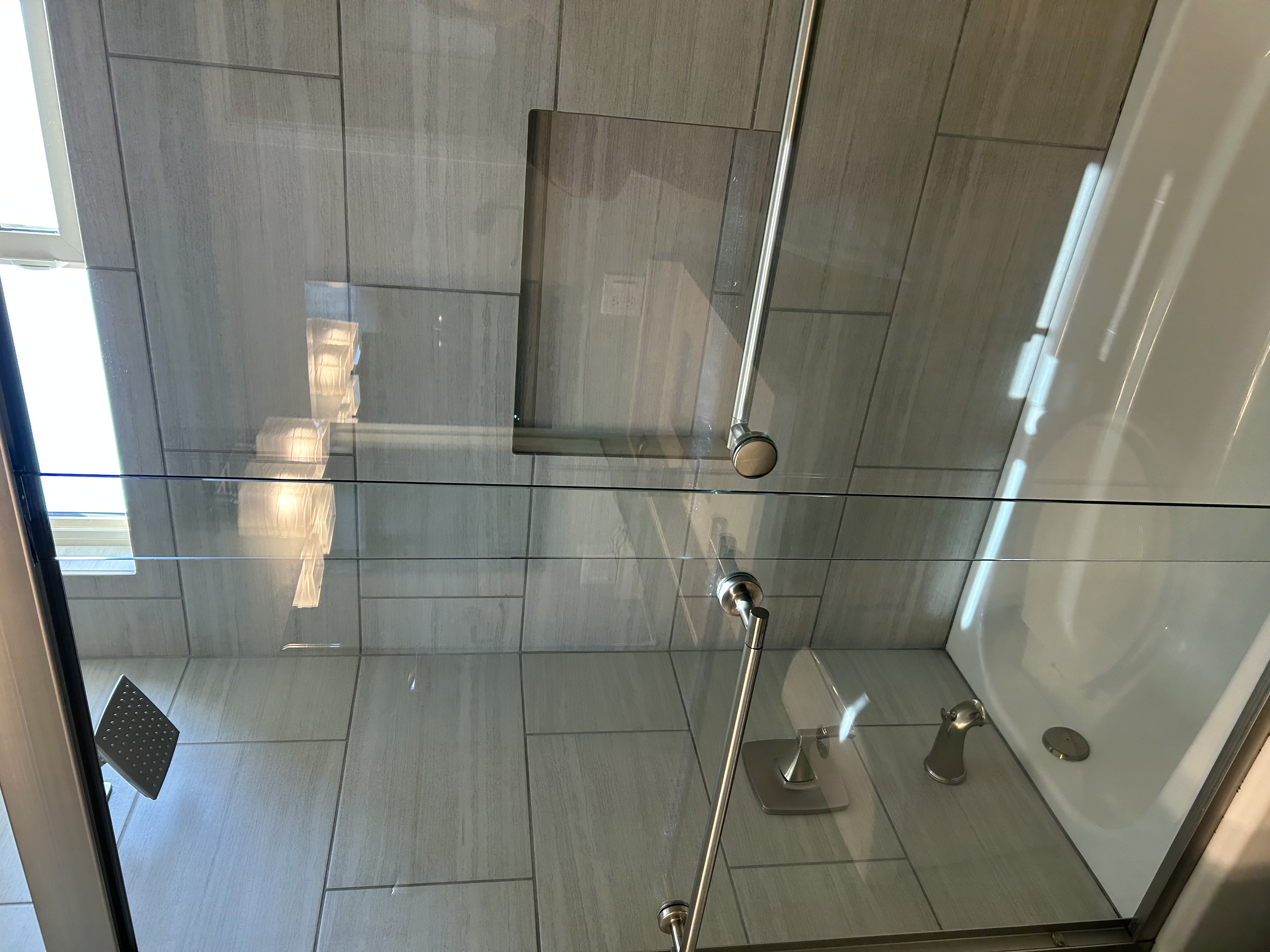 Deep cleaned bathroom shower glass by Tru Cleaning Services