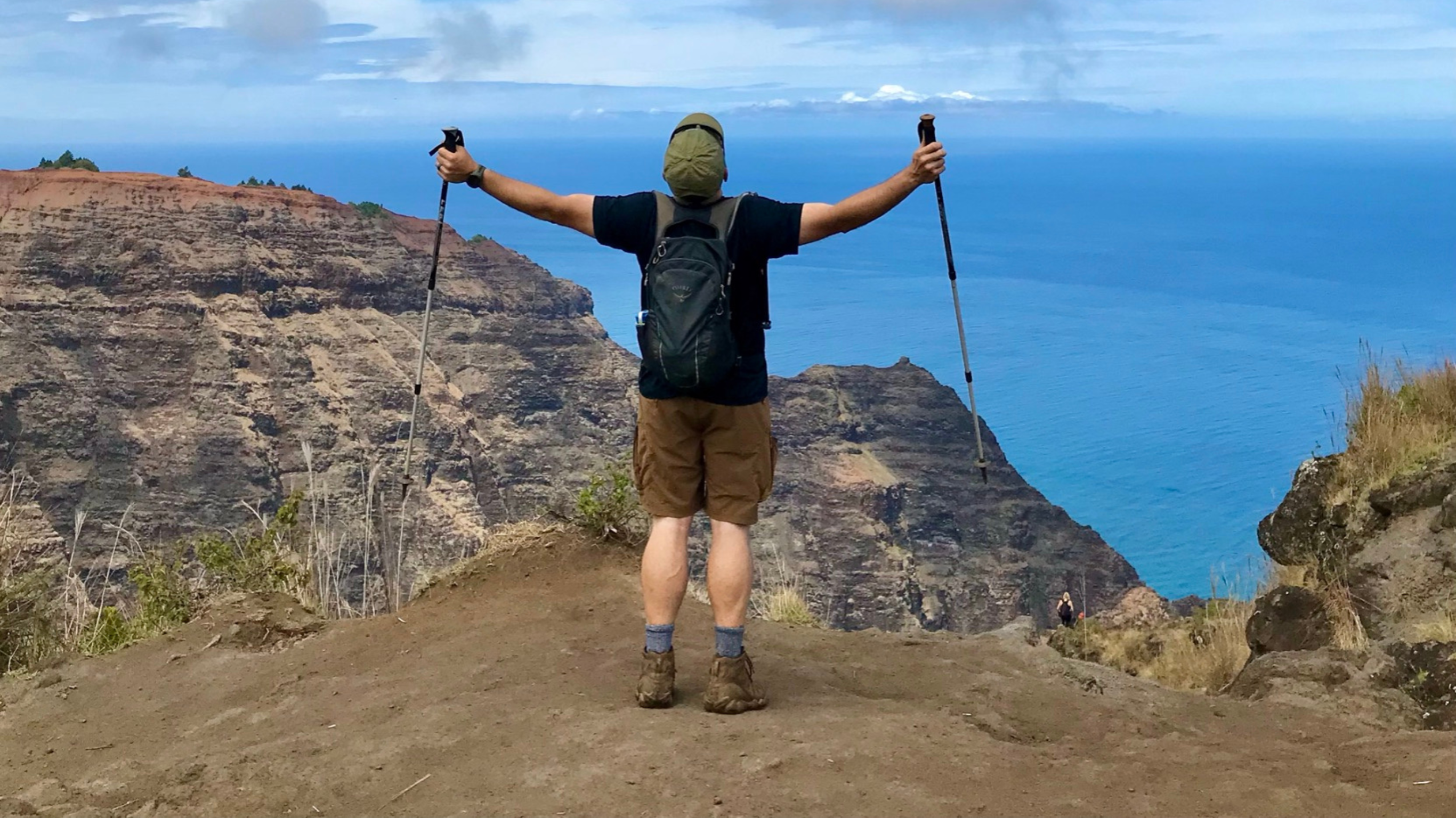 Andy on the Napali Coast, Hawaii — arms outstretched overlooking the ocean