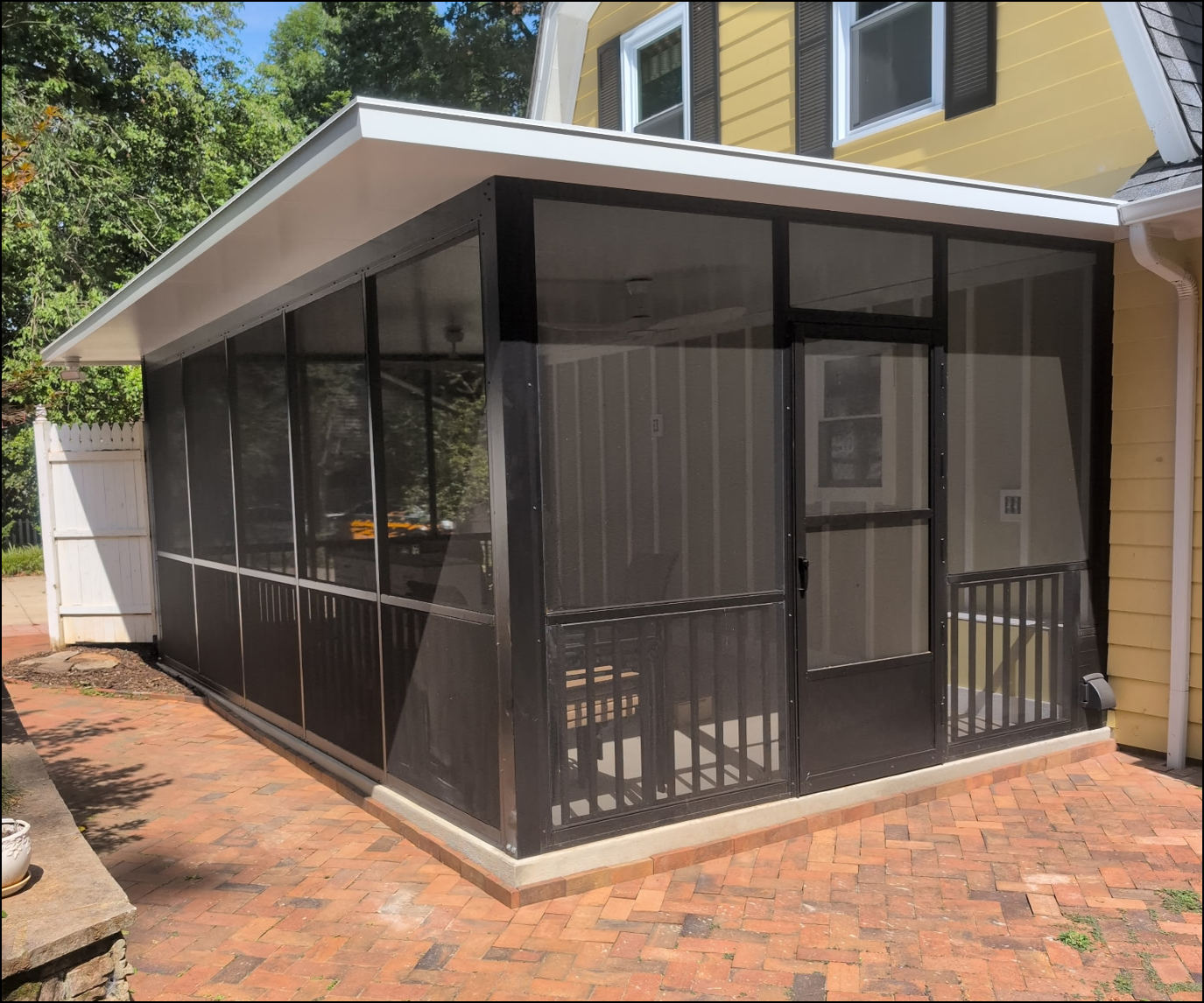Exterior aluminum screen porch attached to a home
