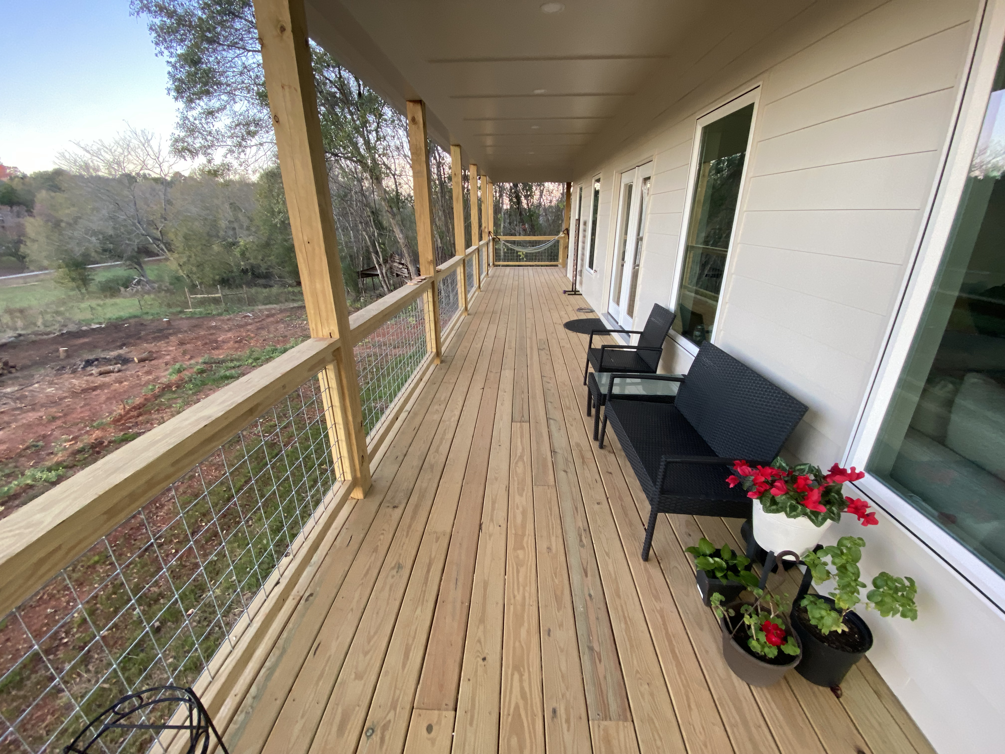 Covered porch and deck with railing and outdoor seating