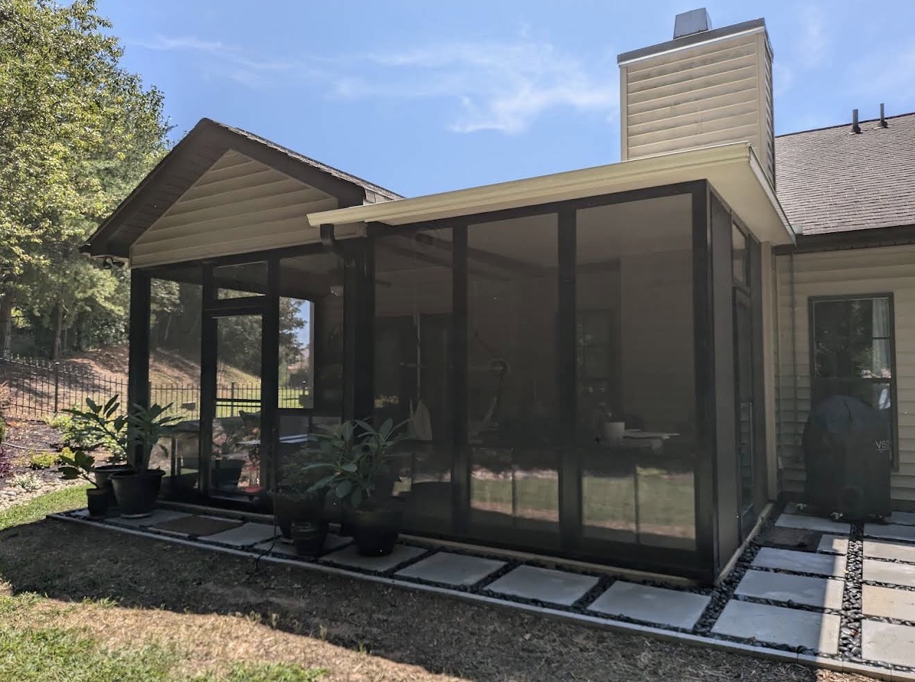 Completed Tirrell porch enclosure showing the expanded covered area integrated with the existing home