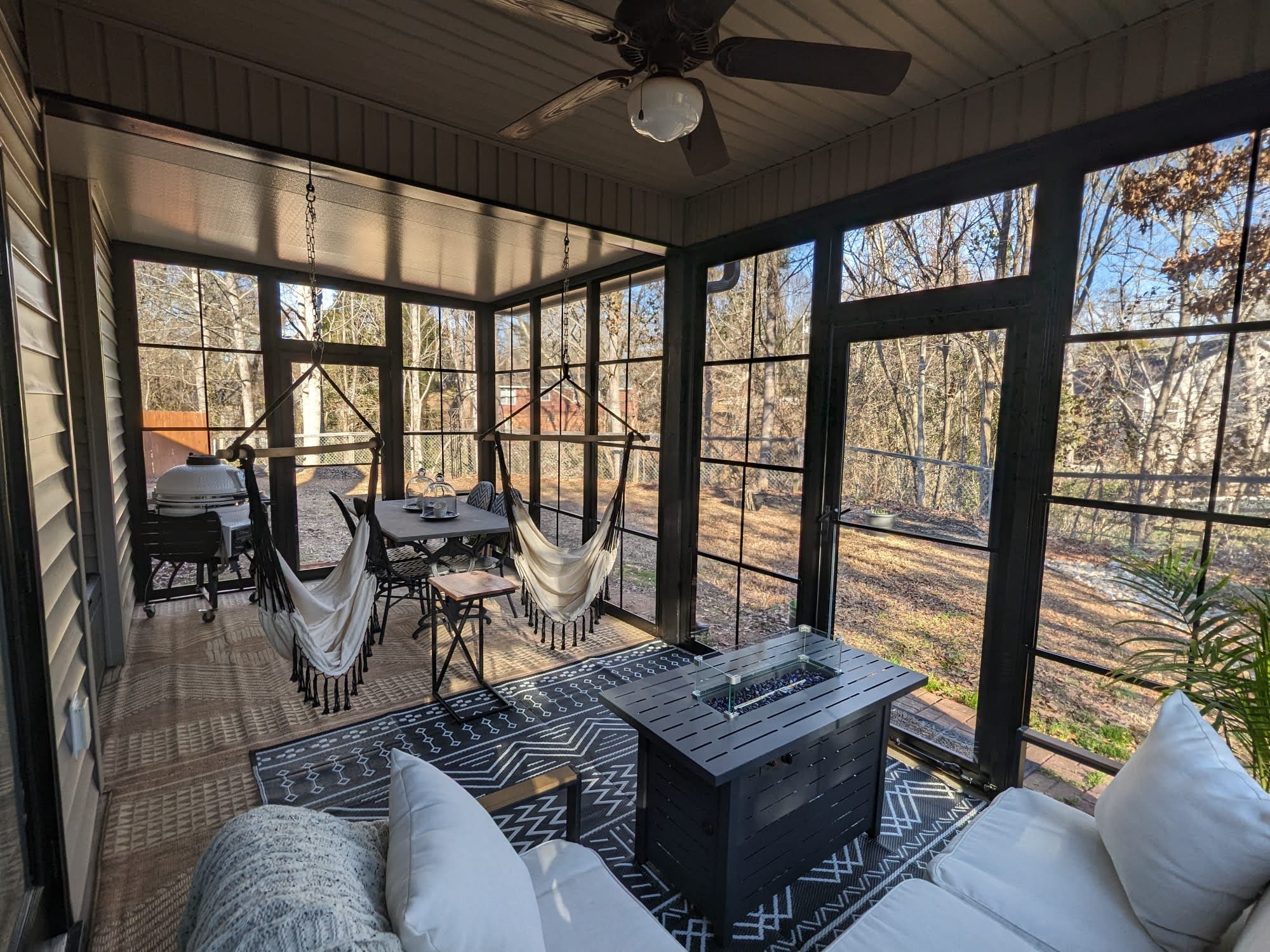 Furnished finished Tirrell Eze-Breeze room with seating, dining space, and outdoor views