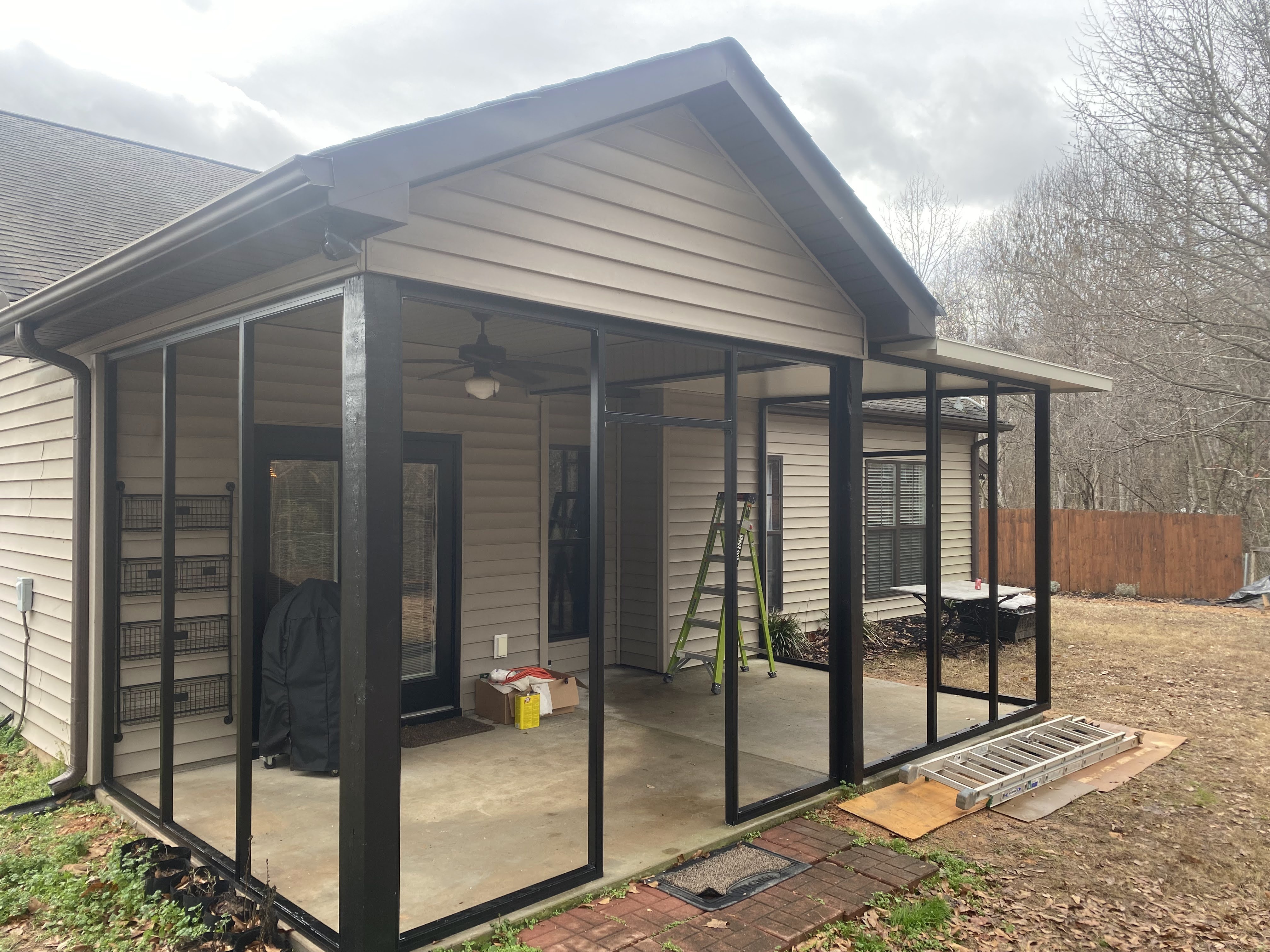 Wide construction view of the Tirrell porch expansion showing the added roof structure and framing