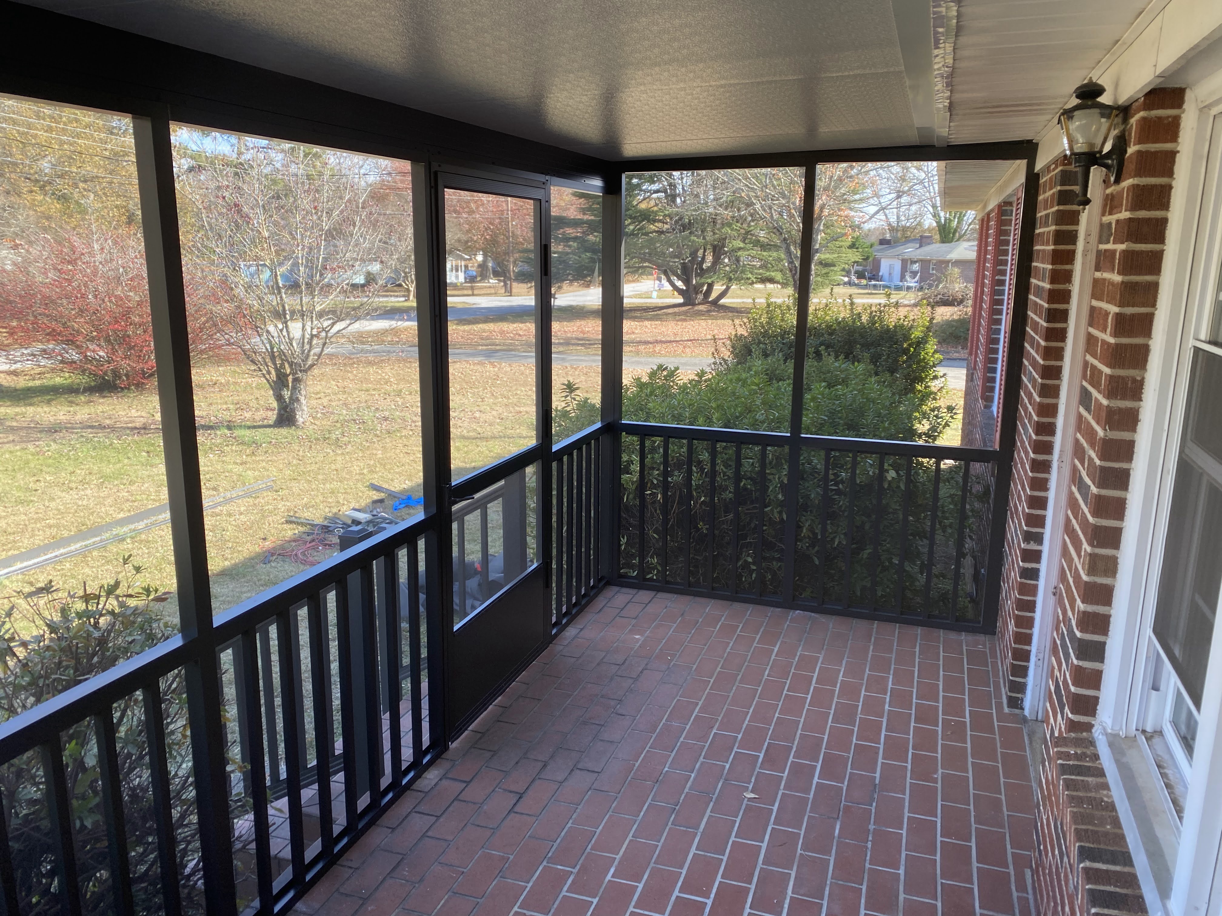 Finished interior of the Rebecca screen porch with structural roof panels and dark framing