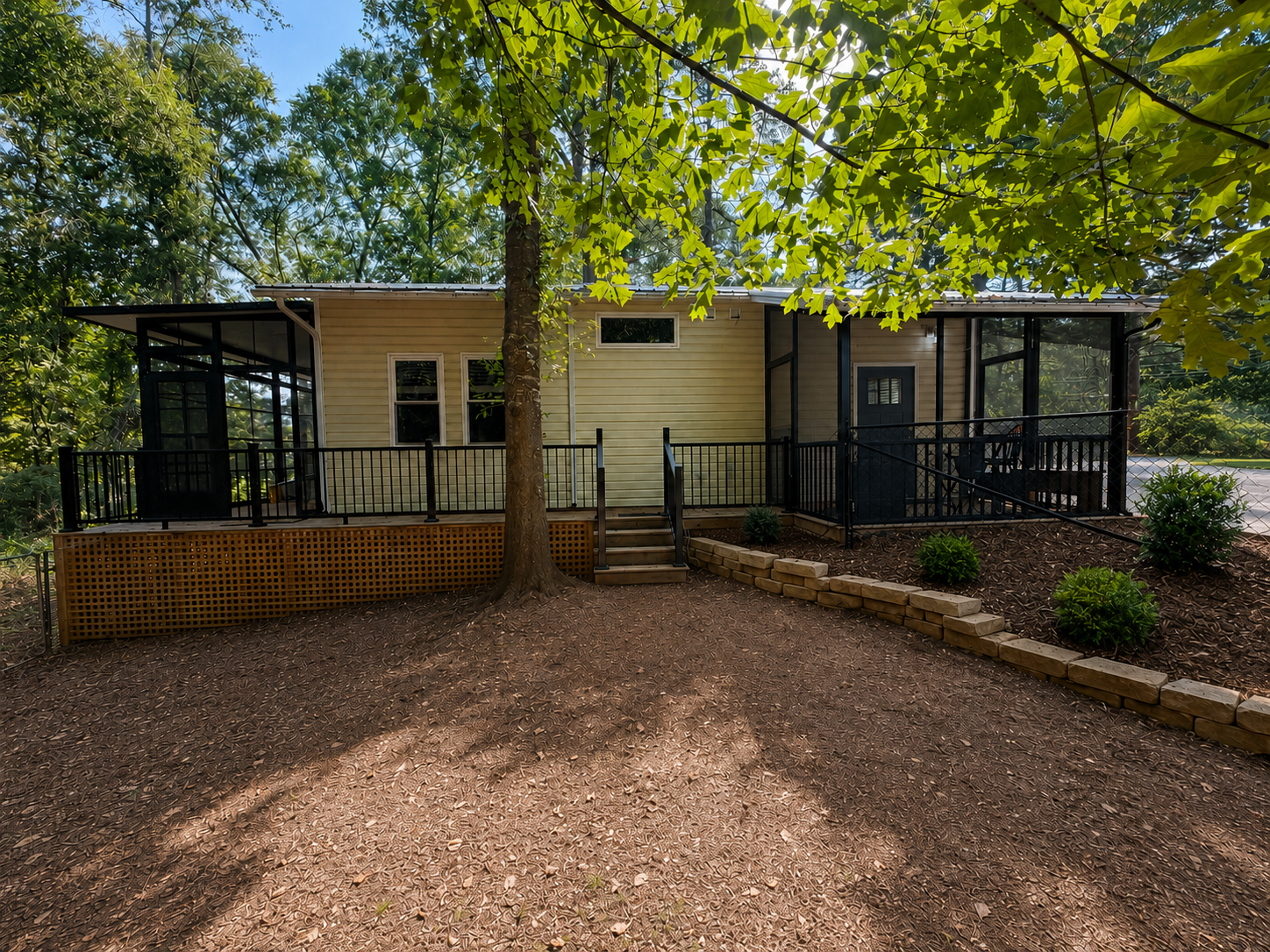 Backyard view of an Eze-Breeze enclosure and separate screen porch in Greenville, South Carolina