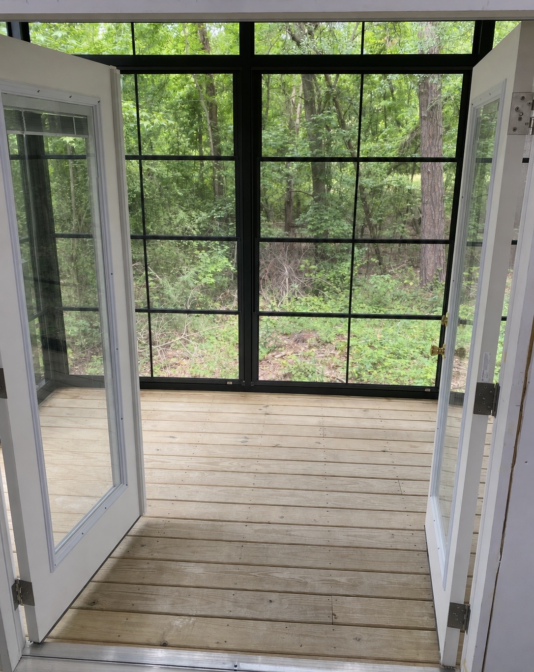 French doors opening from the interior living area into the Greenville Eze-Breeze porch