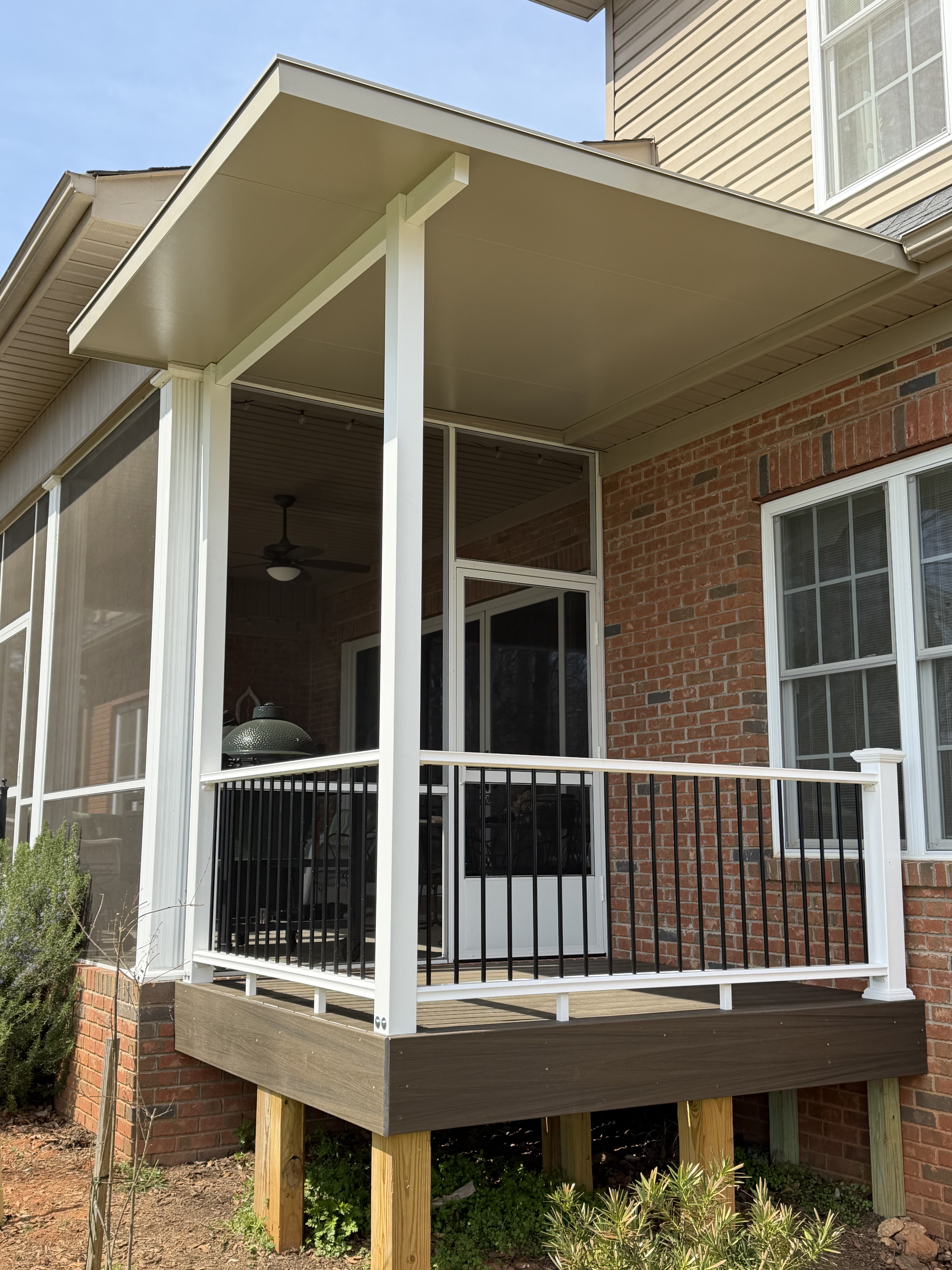 Structural roof panels and powder-coated framing on the Duncan covered porch extension