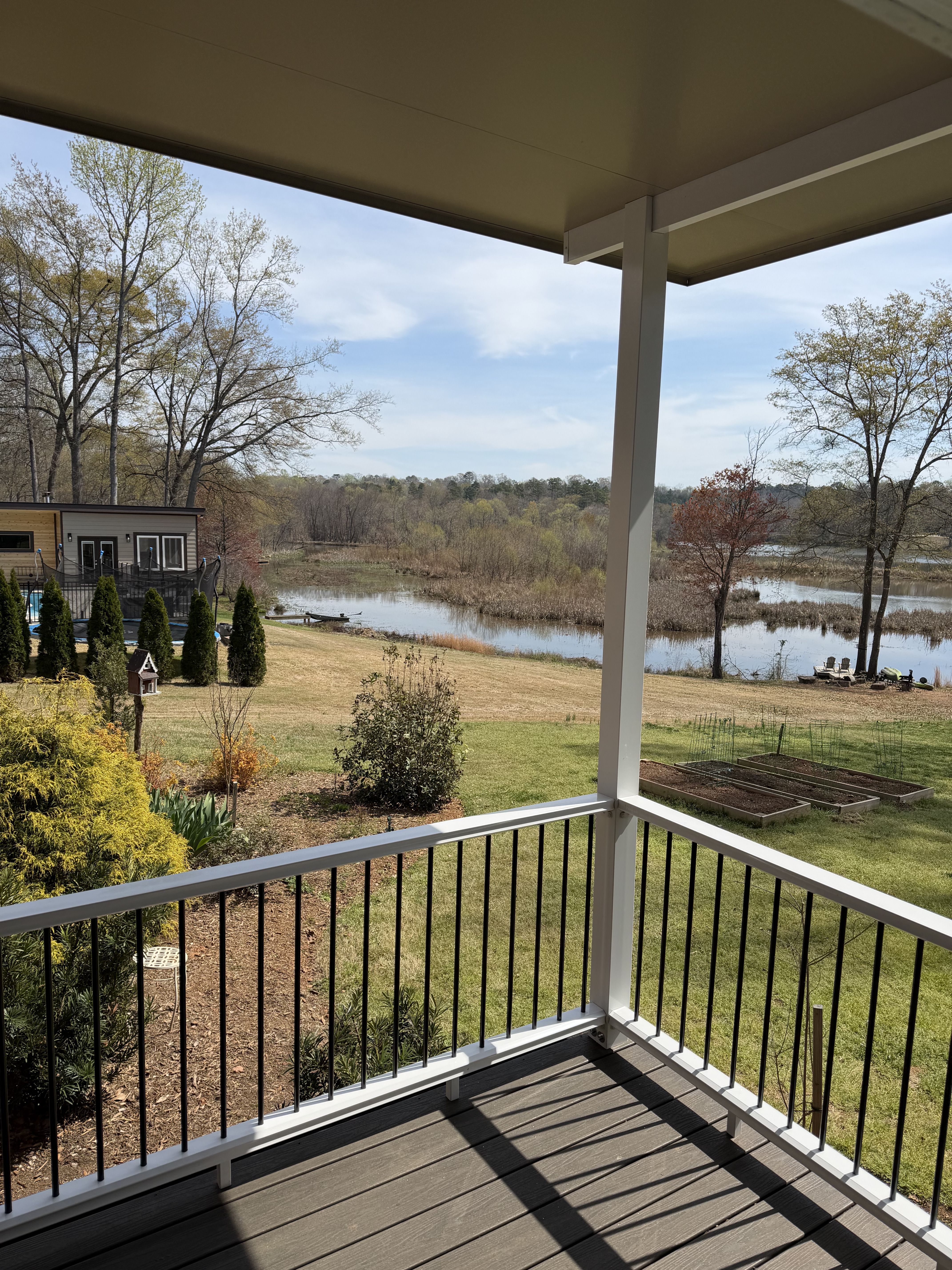 View from beneath the new covered porch extension toward the yard and water in Duncan, South Carolina