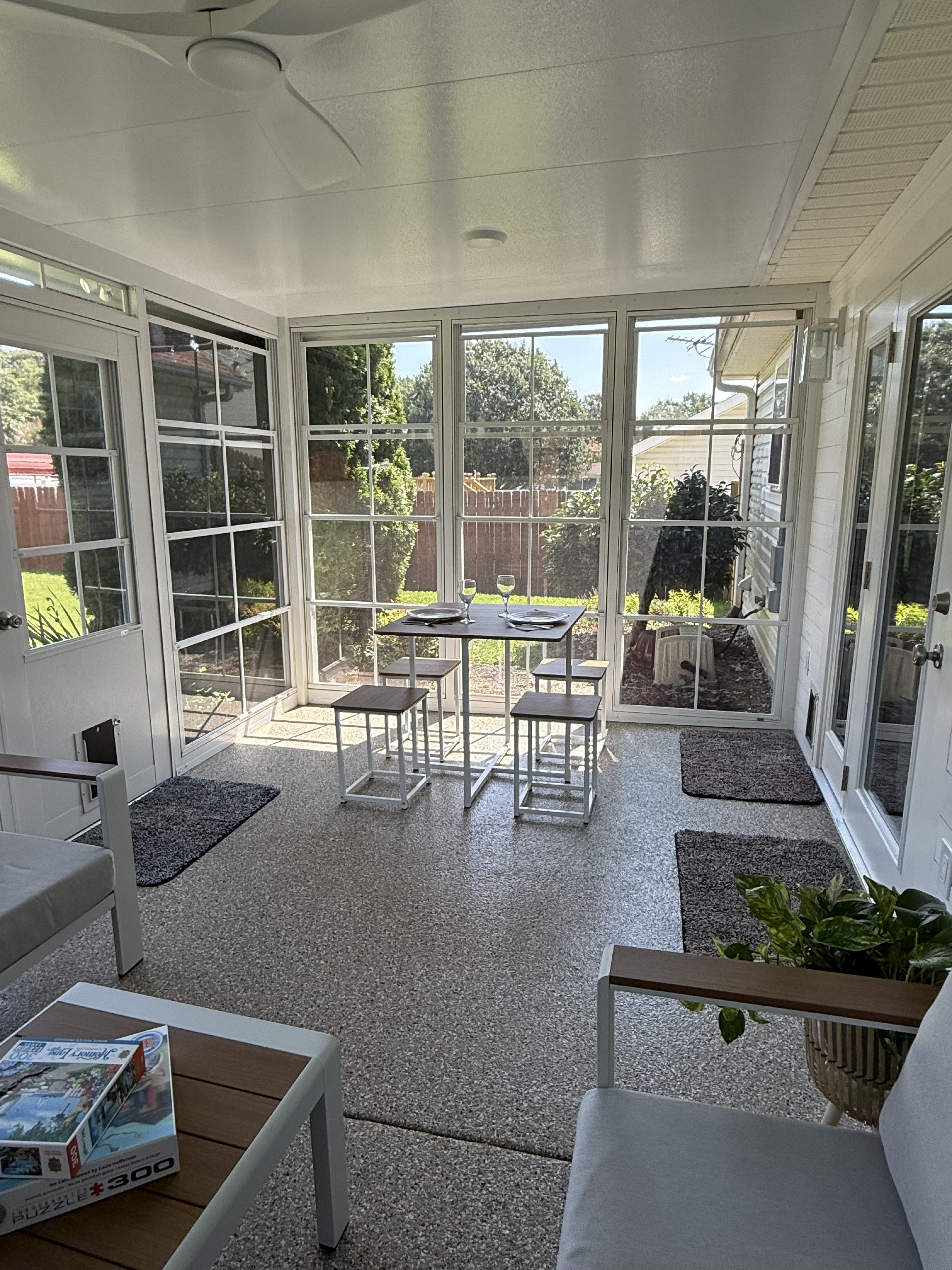 Furnished dining area inside the completed Hill Eze-Breeze outdoor room