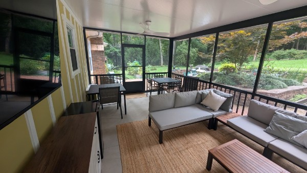 Finished Brandon screen porch with seating and dining areas in Anderson, South Carolina