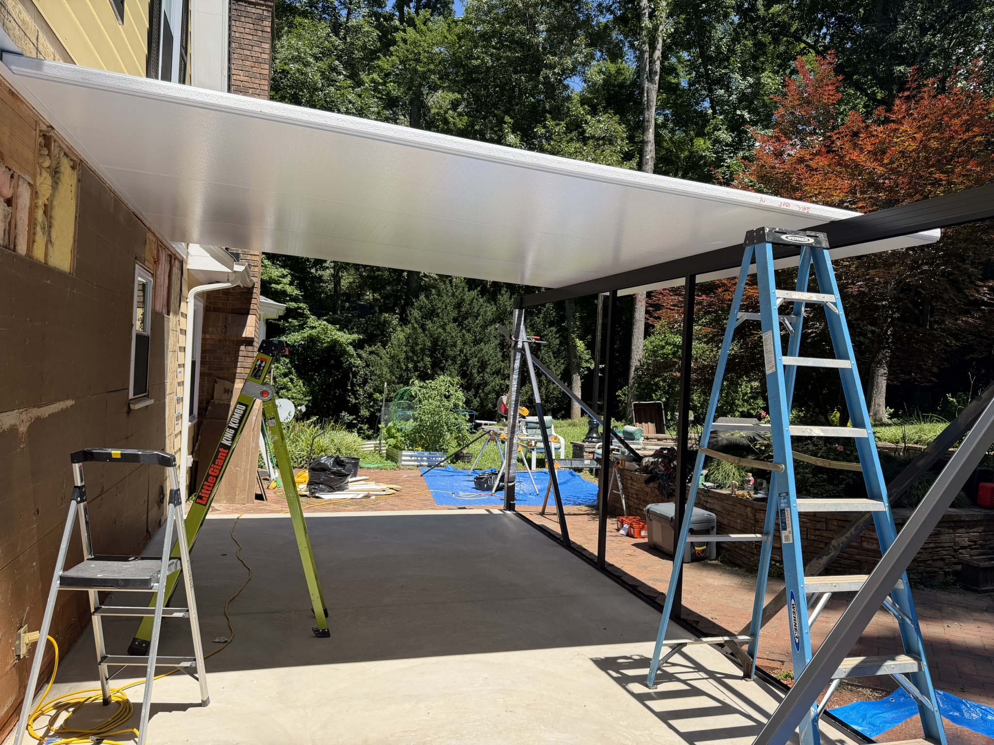 Insulated structural roof panels and aluminum framing during construction of the Anderson screen porch