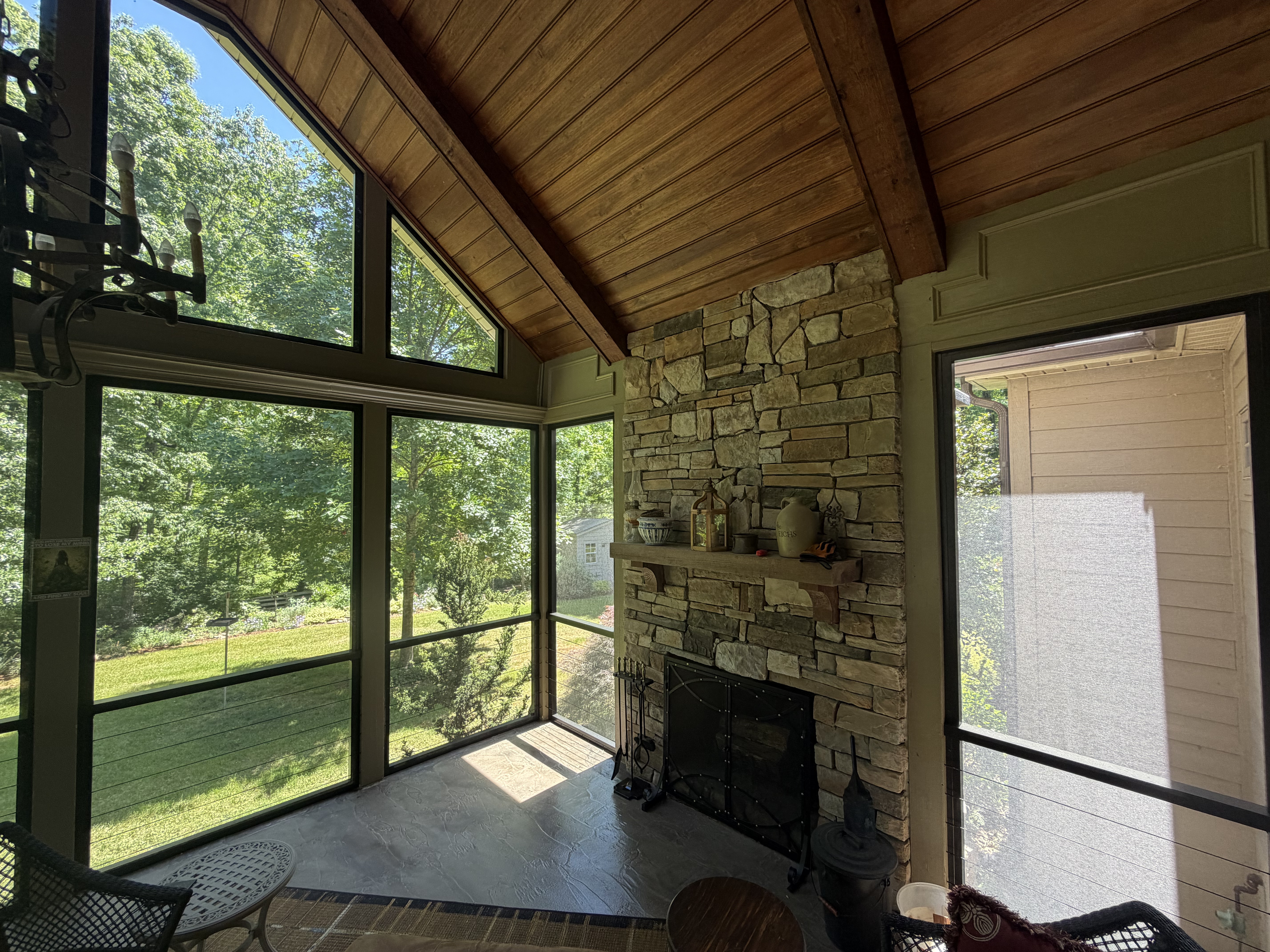 Finished Eich screen porch with fireplace and views into the surrounding greenery