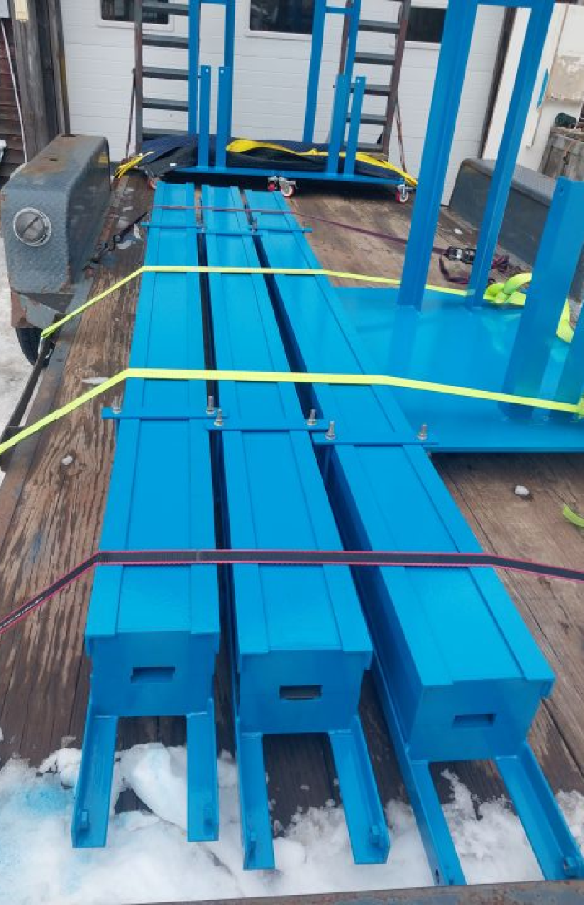 Custom fabricated blue steel components secured for delivery by Warrior Welding, specialists in structural and mobile welding