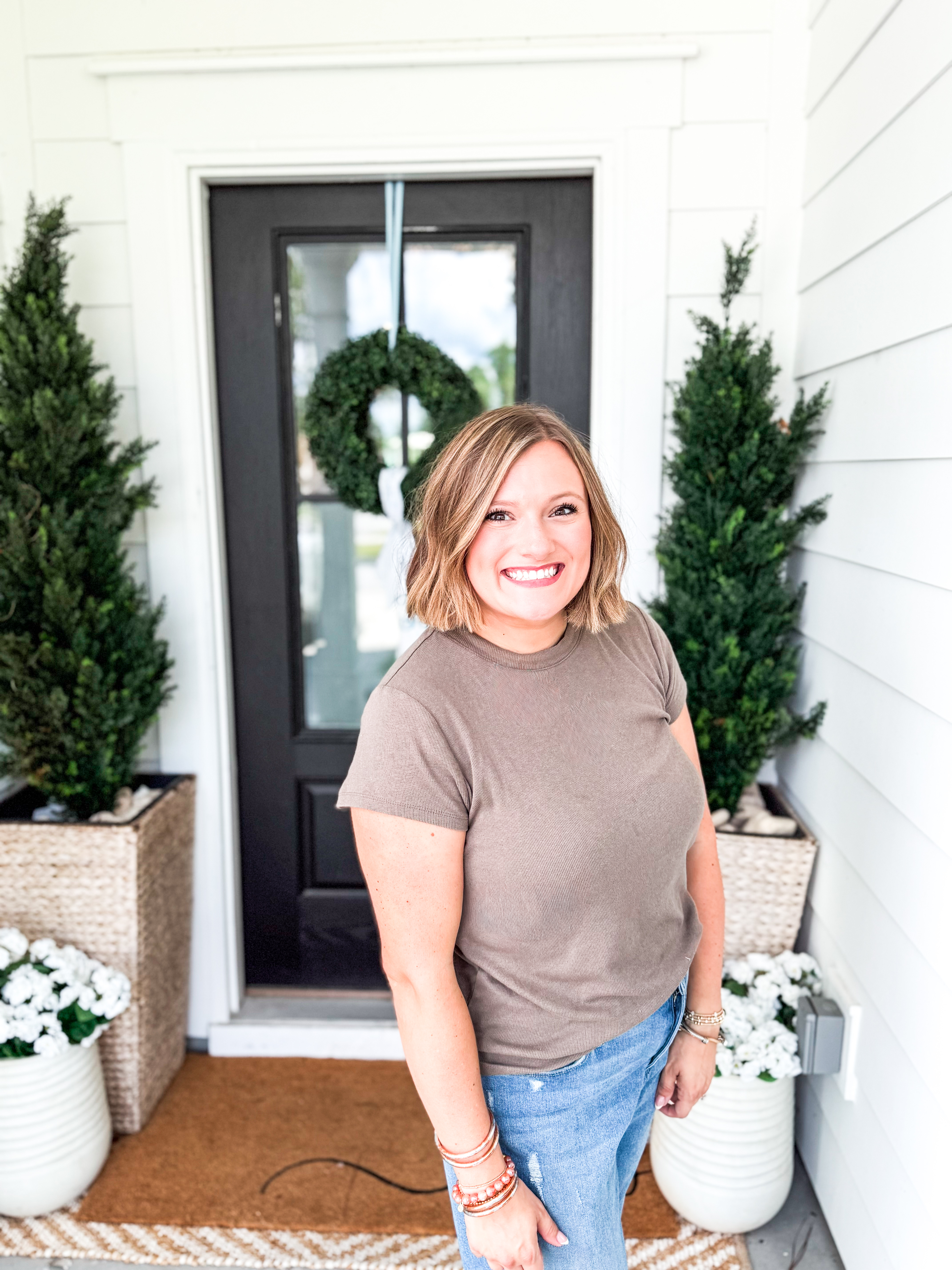 Jessica Fowler — Founder of Fowler Design Studio, standing at porch entry